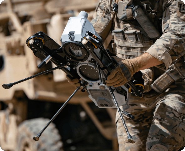 Soldier holding a drone. 